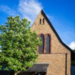 Katholische Kirche Selzen mit Kastanienbaum und Turmfalke